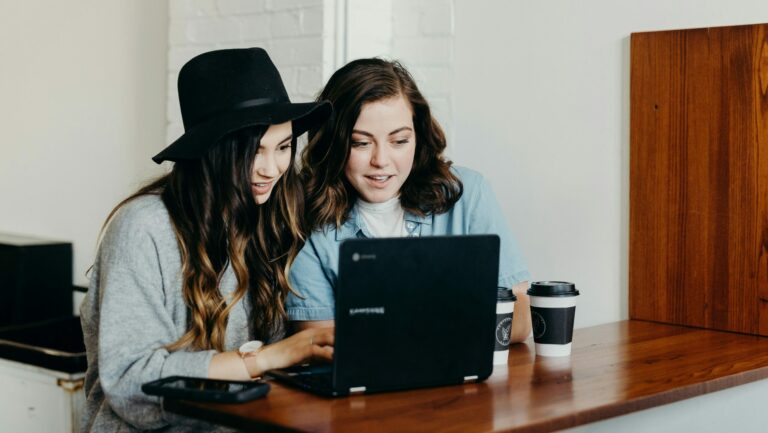 two girls working on a blog website